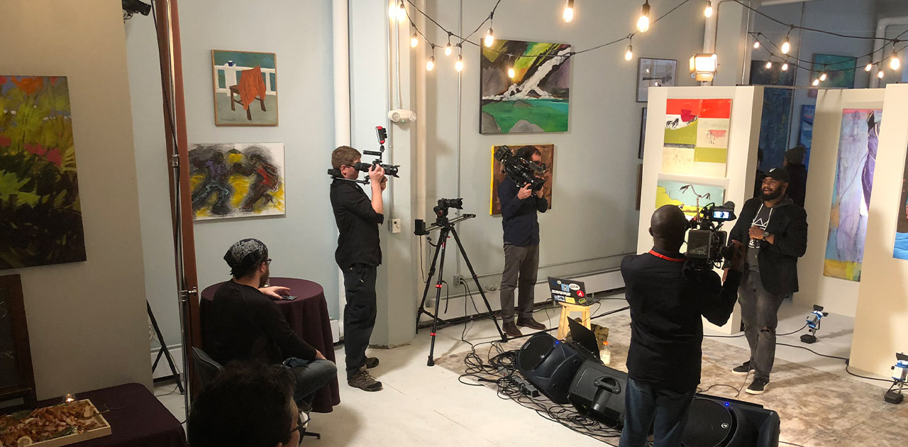 Behind the scenes photo shoot in an art gallery with hanging cafe' lights