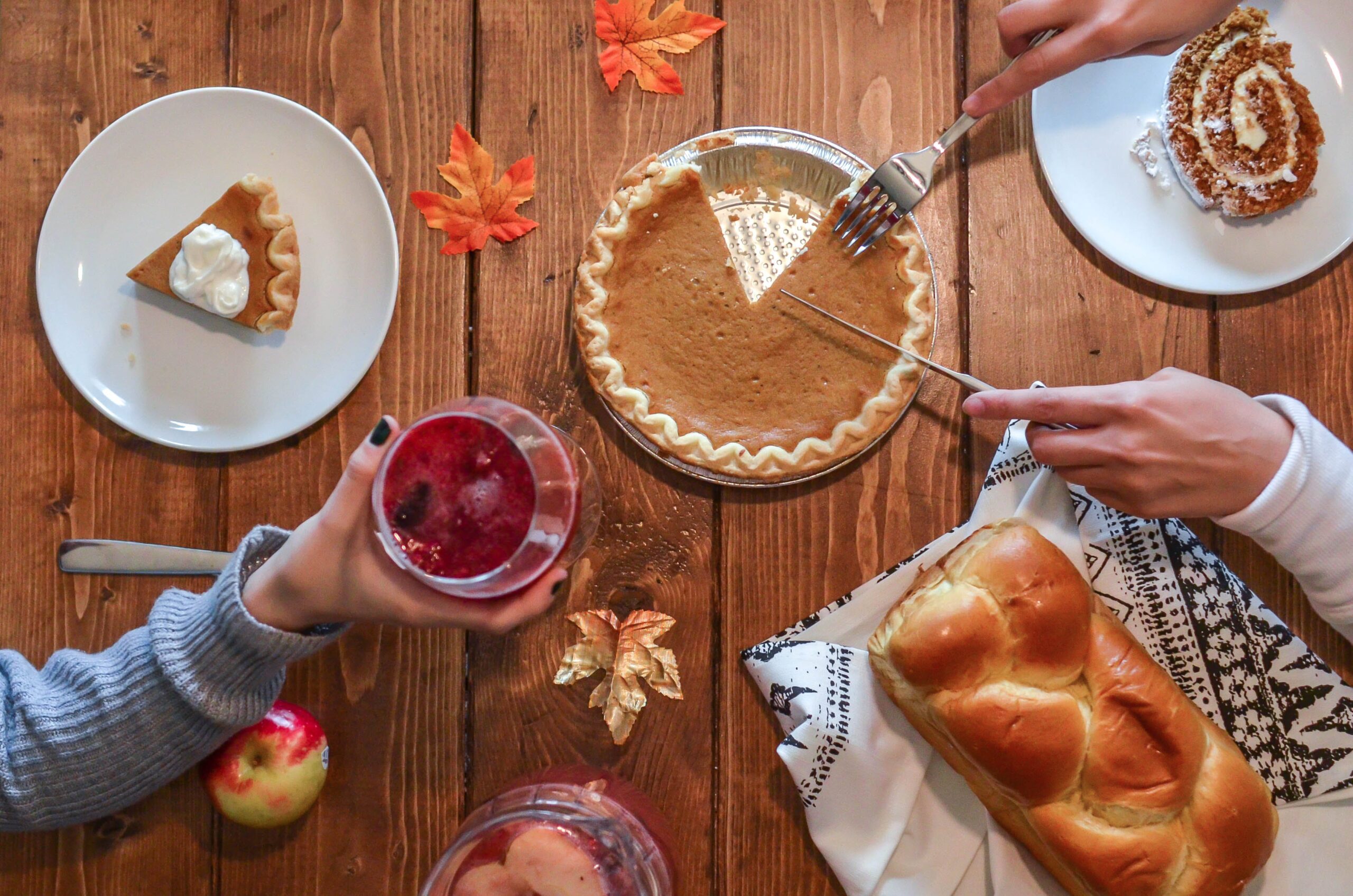 Thanksgiving Table Setting with pie, bread and a beverage