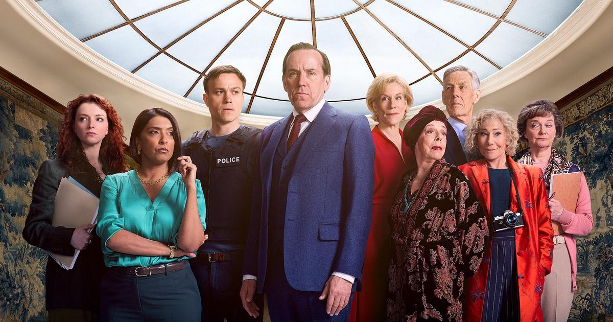A group of people standing under a skylight